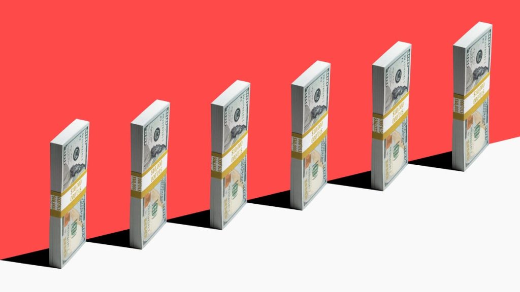 Bundles of bills stand vertically against a red background