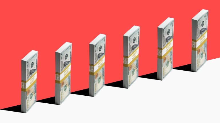 Bundles of bills stand vertically against a red background