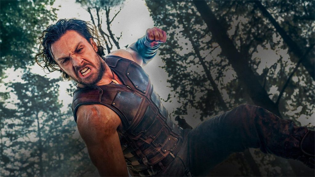 A still from the movie Kraven the Hunter showing actor Aaron Taylor-Johnson throwing a punch.
