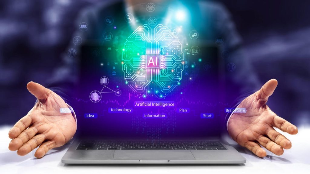 Neon sparkles rise up from a laptop with the floating letters AI