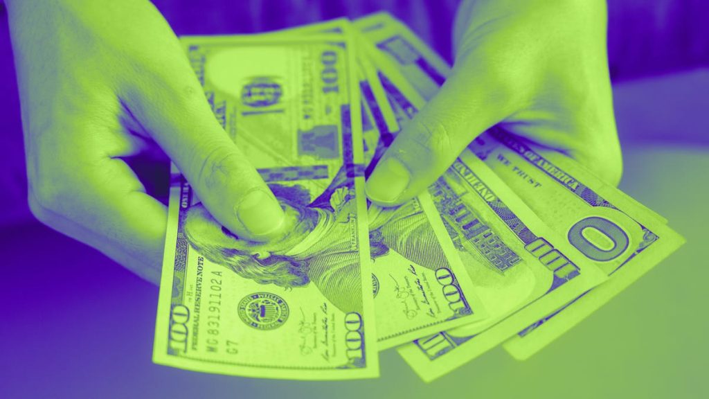 Hands holding US money
